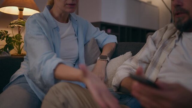 Man confronting woman while showing her something on his smartphone during an argument, illustrating trust issues, relationship conflict, jealousy, social media problems and emotional tension.