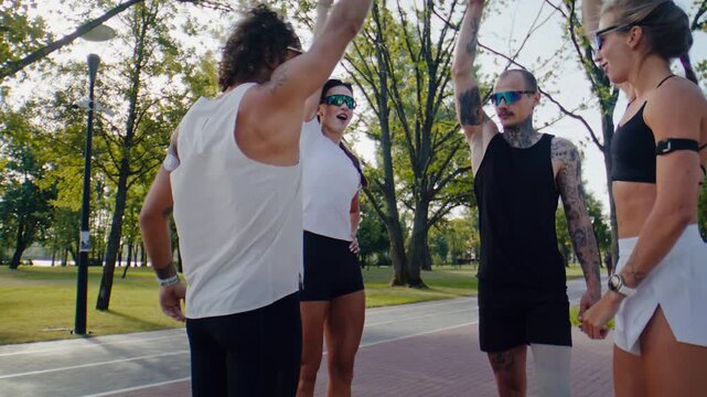 Running group joins hands together after outdoor training session