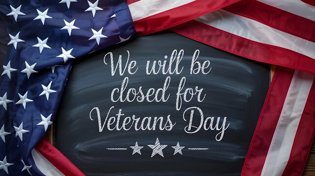 Veterans day closure sign with American flag background chalkboard sign announcing that a business or office will be closed for the veteran's day holiday with patriotic decor