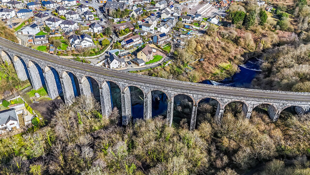 A view directly above the curved Cefn Coed Viaduct and a residential part of Merthyr Tydfil, Wales on a sunny day