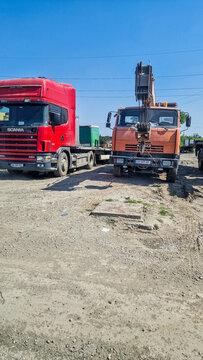 KamAZ Klintsy KC-55713 truck cranes under a blue sky near Tbilisi; heavy-duty Russian crane trucks; construction vehicles; Georgia
