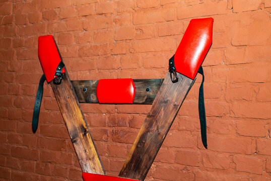 SM cross or Andreaskreuz is used in the BDSM scene on red background