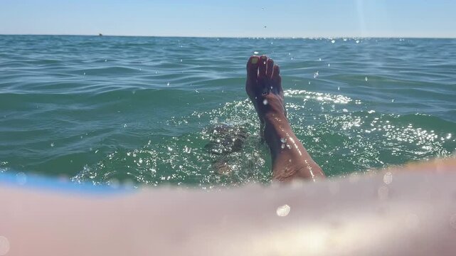 Woman relaxing in inflatable ring in the sea. 4k
