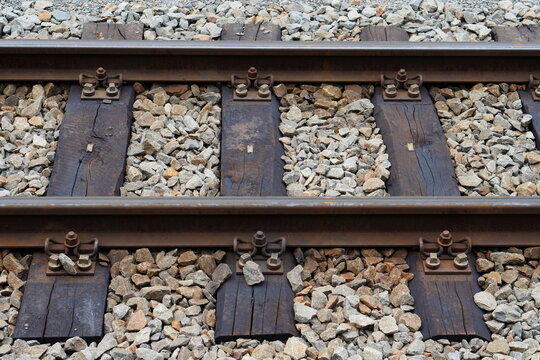 Close Up View of Steel Railway Track with Wooden Ties and Gravel