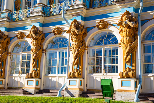 Golden statues guard elegant blue and white windows