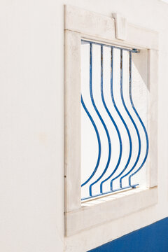 close up of curved blue railing against whitewashed window, minimal, architectural detail, negative space
