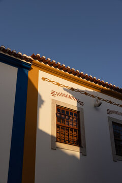 low angle of traditional Portugese building with bold colors and shadows