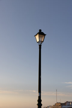 minimal shot of traditional street light at dusk with soft skies