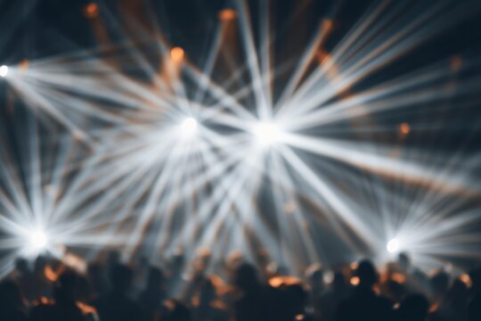 Concert stage spotlight beams illuminating dancing crowd. Nightclub party music event laser illumination