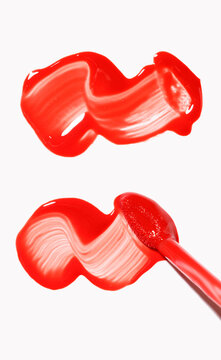 two red lip gloss swatches with applicator, cosmetics beauty product texture, liquid blush, lipstick swatch with brush