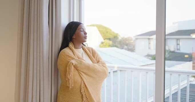 Camera pushing African American adult woman in shawl at door breathing calming smiling, copy space