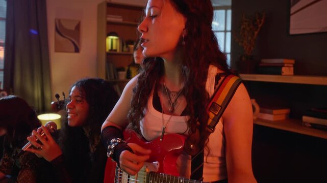 Diverse teenagers playing electric guitar, singing, and performing keyboard during home band rehearsal. Clip is perfect for youth lifestyle and music education advertisements