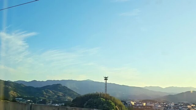 Riding on a shinkansen high speed train passing a japanese rural city at sunset, track, Rural Travel Journey, Train Railway Transportation, Passenger Window POV