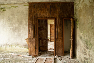 Abandoned old building without renovation, with traces of dampness and mold and a wooden doorway © Виктория Котлярчук