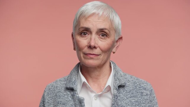 Senior Woman Nodding Head in Approval on Pink