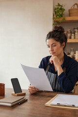 Fototapeta premium Small business owner checking a bank transfer request