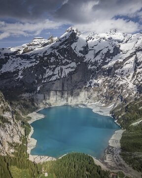 Aerial view, Lake Oeschinen with snow-covered mountains, Kandersteg, Bernese Oberland, Switzerland
