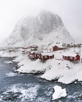 Snowstorm, red stilt houses, Hamnoy, drone shot, Lofoten, Norway