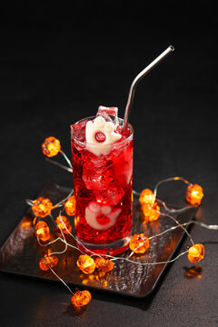 Festive Halloween Cocktail with Ghost Ice Cubes and Pumpkin Lights for a Spooky Celebration