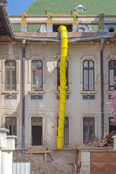 Yellow Plastic Long Chute for Building Debris at Construction Site in Craiova Romania