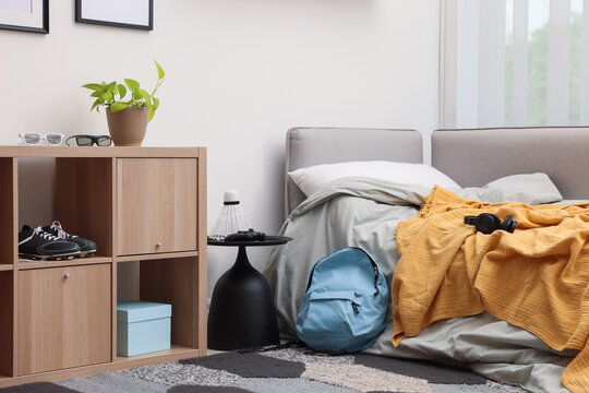 Teenager's room with stylish furniture and houseplant. Interior design