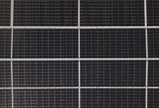 Portugal - 14 August 2026: Aerial view of solar panels installed on a factory rooftop, showcasing decentralized energy production and sustainable infrastructure.