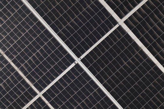 Portugal - 14 August 2026: Aerial view of solar panels installed on a factory rooftop, showcasing decentralized energy production and sustainable technology.