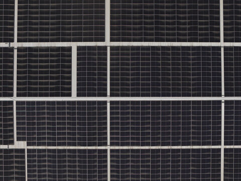 Portugal - 14 August 2026: Aerial view of solar panels installed on a factory rooftop, showcasing decentralized energy production.