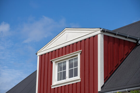 Classic Swedish Wooden House Dormer with Red Wood Siding and White Trim