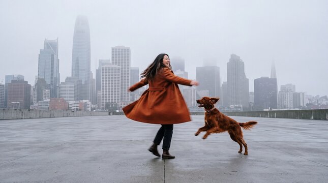 Happy Young Woman Dancing with Dog Outdoors in City