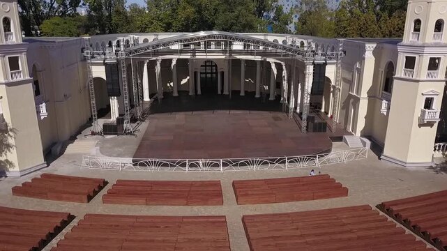 Drone flies low above classic open stage