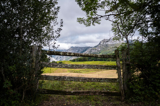 Wooden fence gate framing a misty mountain valley
