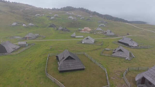 Aerial footage showing the unique wooden herdsmen's huts and cottages of Velika Planina, an alpine plateau in the Kamnik Savinja Alps