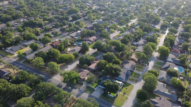 Linear residential avenues span quiet single family subdivisions west of Precinct Line Road. Fenced yards, private swimming pools, thick treetop foliage display suburban comfort, Hurst, Texas