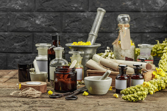 Rustic apothecary scene with Verbascum flowers, herbal jars, vintage tools and mortar