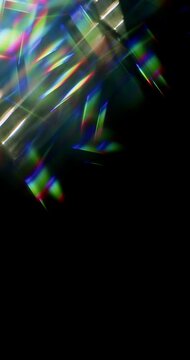 Light ray shining through a prism for angled beams of sparkling shine in brilliant colors. Swirling reflective glass with beaming lights creating visual effect of a brilliant dazzling rainbow. Loop.