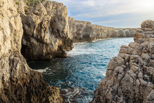 Rugged coastal cliffs meet the deep blue sea in a dramatic natural landscape