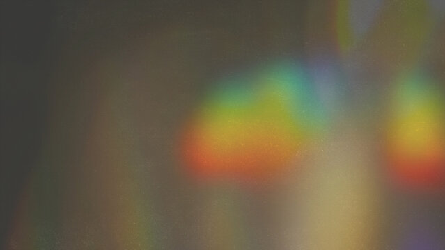 Rainbow light leak overlay texture with electric color wave pattern glowing across psychedelic textured screen for backdrop