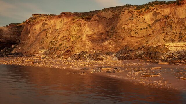 dramatic cliff face at golden hour exposed strata and sediment, pebble strewn shore, calm tide and textured layers for scientific observation