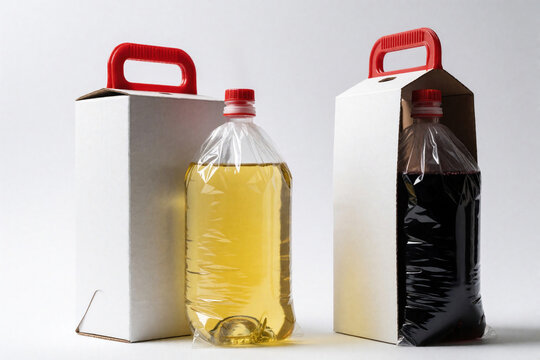 Two large plastic wine bags with tap caps stand next to white cardboard carrier boxes. One bag contains white grape juice white wine bag holds red merlot. Disposable eco friendly liquid packaging on
