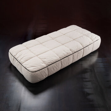 designer single bed in quilted beige fabric.