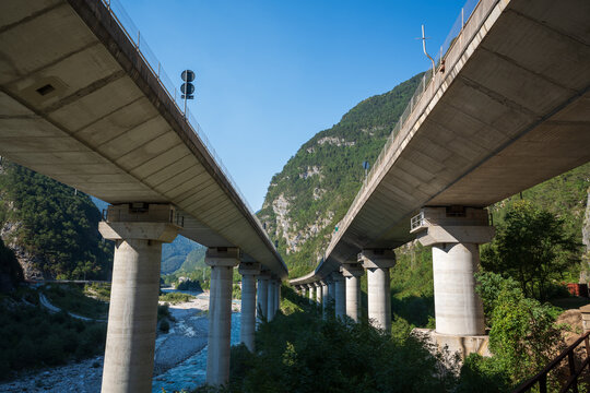 imposing reinforced concrete viaducts with cylindrical pylons typical of the mountain sections of the A23 motorway in Italy