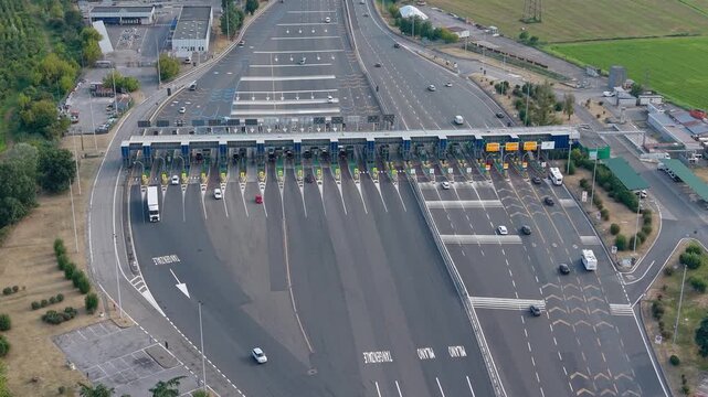 Aerial view of the Barriera A7 Milano Ovest toll plaza in Assago, Italy, showing toll lanes and road infrastructure on the Milan motorway network.