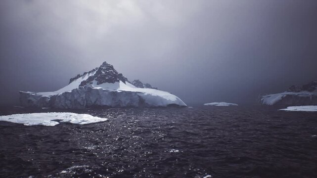 bleak glacier edge over churning sea, fractured ice shelves and dark water, subtle light revealing melt patterns, climate monitoring perspective from vessel