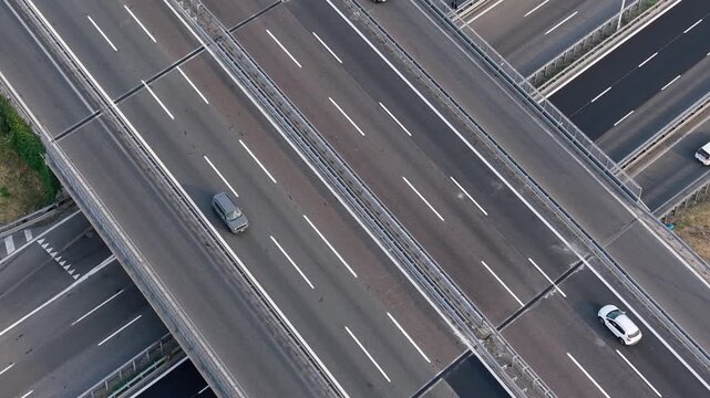 Aerial view of vehicles traveling along the A7 motorway near Milan, Italy, showing urban connectivity, road infrastructure and daily transportation.