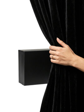 Hand pulling black curtain to reveal gift box, transparent background