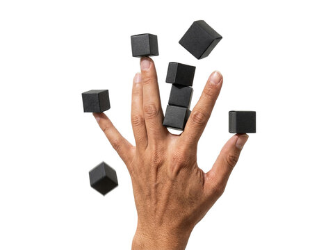 Hand balancing small black geometric cubes, transparent background