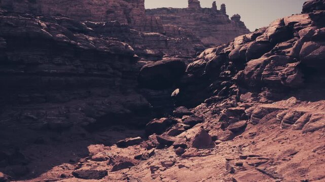 Wide desert vista ideal for travel, dramatic rock silhouettes against pale sky, textured foreground, inspirational branding potential for tourism campaigns