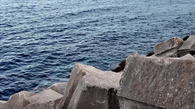 Heavy concrete breakwater blocks protecting the sea shore interlocking tetrapods