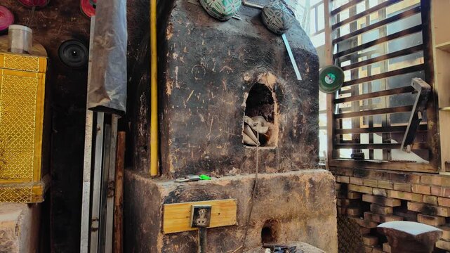 Traditional Uyghur blacksmith forging iron in Kashgar